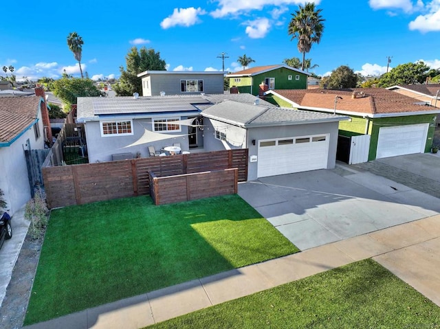 view of front of property featuring a front lawn and a garage