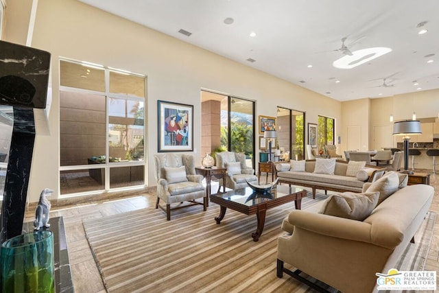 living room with a wealth of natural light and ceiling fan