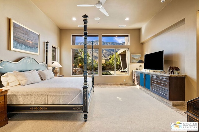 bedroom featuring light carpet and ceiling fan