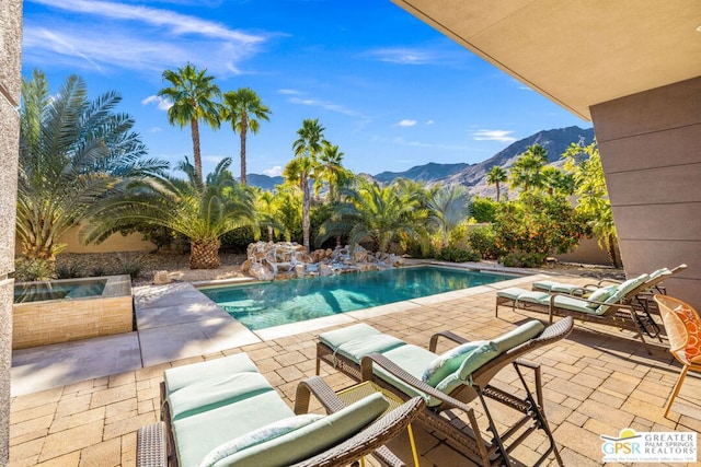 view of swimming pool featuring a mountain view and a patio area