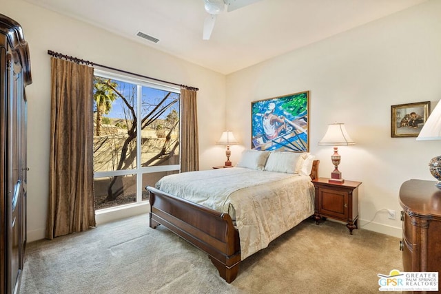 bedroom with ceiling fan and light carpet