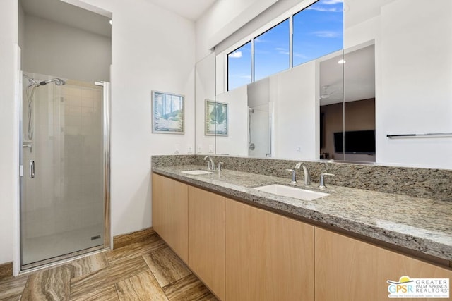 bathroom with a shower with door and vanity