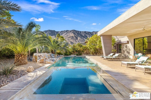 view of pool featuring a mountain view and a patio area