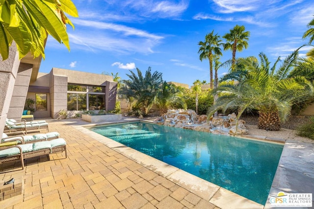 view of swimming pool featuring a patio