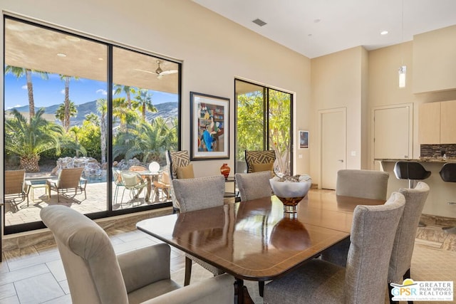 dining room with light tile patterned flooring and a mountain view