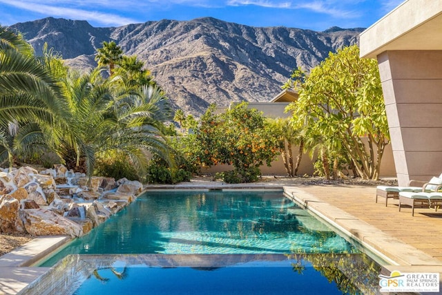 view of pool featuring a mountain view and a patio area