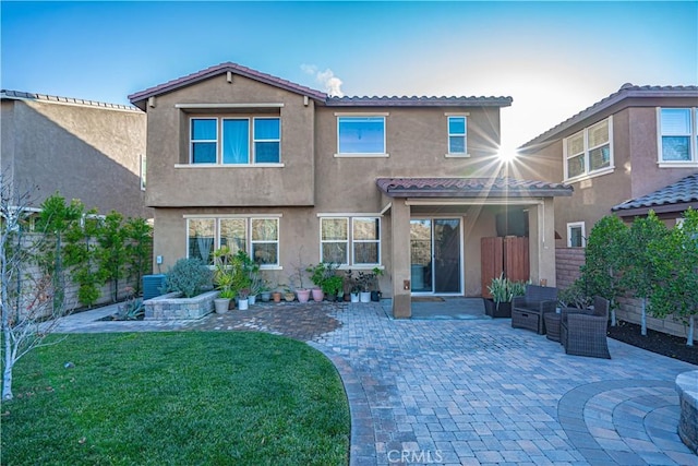 rear view of house with a patio area and a lawn