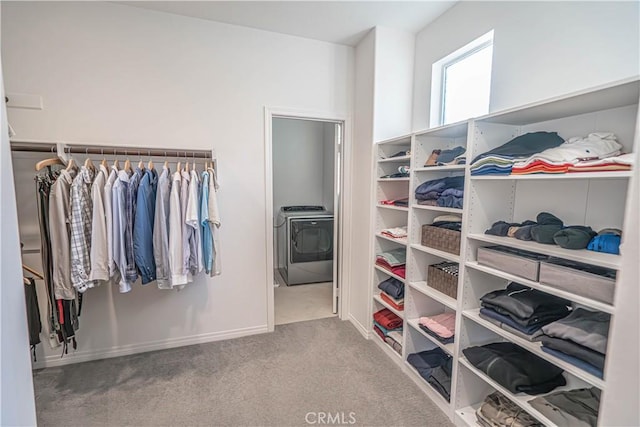 spacious closet with washer / clothes dryer and carpet