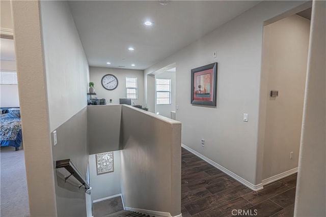 corridor with dark hardwood / wood-style flooring