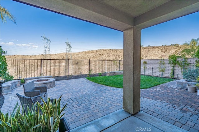 view of patio with a fire pit