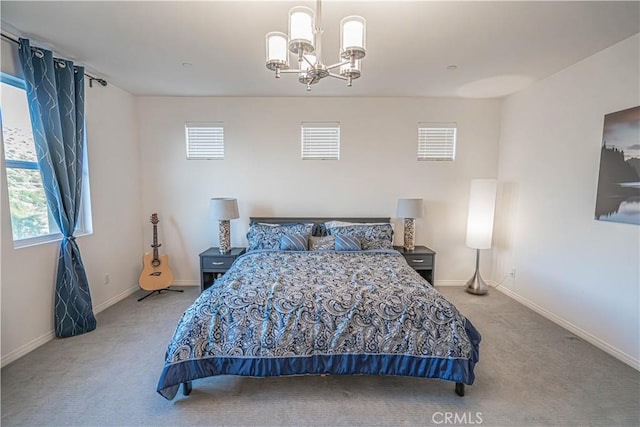 bedroom with an inviting chandelier and light carpet