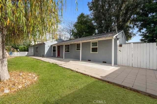 back of house featuring a patio area and a yard