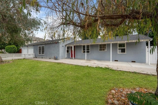 back of house featuring a yard and a patio