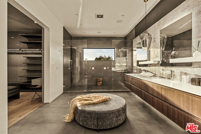 bathroom with a shower, vanity, and concrete flooring