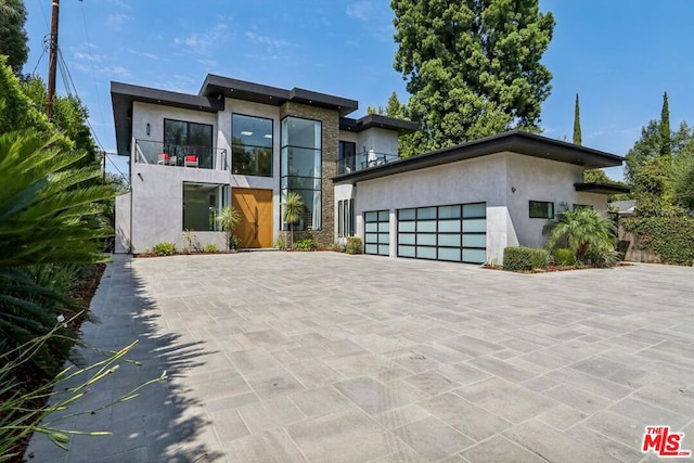 contemporary house featuring a balcony and a garage