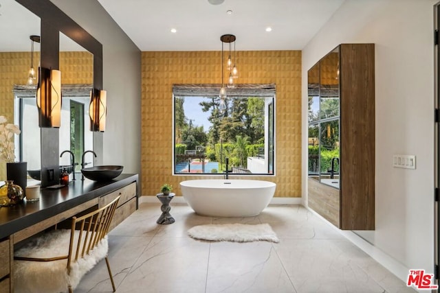 bathroom featuring vanity and a tub to relax in