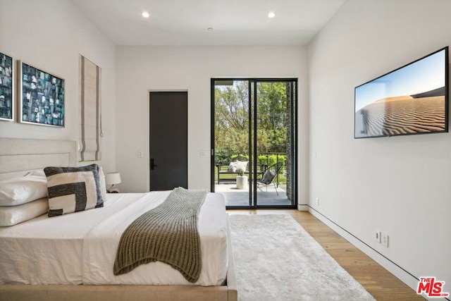 bedroom featuring light wood-type flooring and access to outside