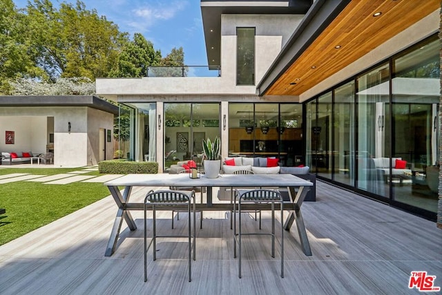 wooden terrace featuring outdoor lounge area