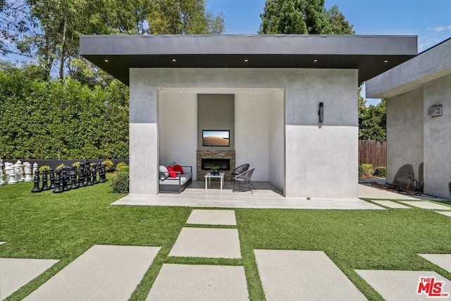 exterior space featuring a lawn and an outdoor stone fireplace