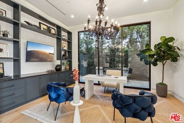 living area featuring light hardwood / wood-style flooring and an inviting chandelier