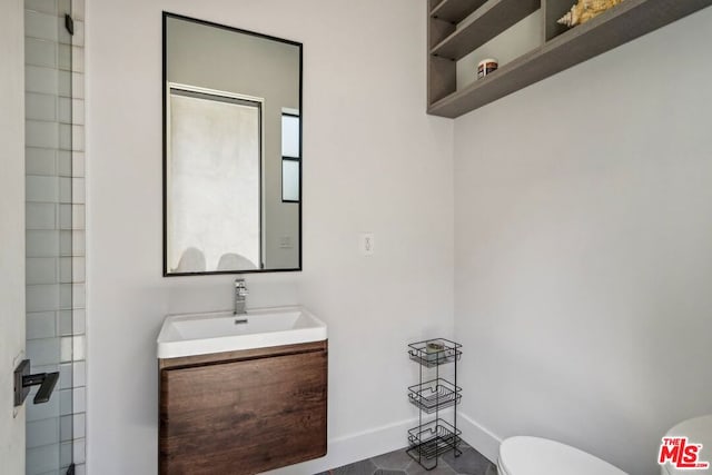 bathroom with toilet and vanity