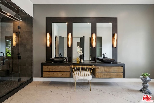 bathroom featuring vanity and a shower with shower door