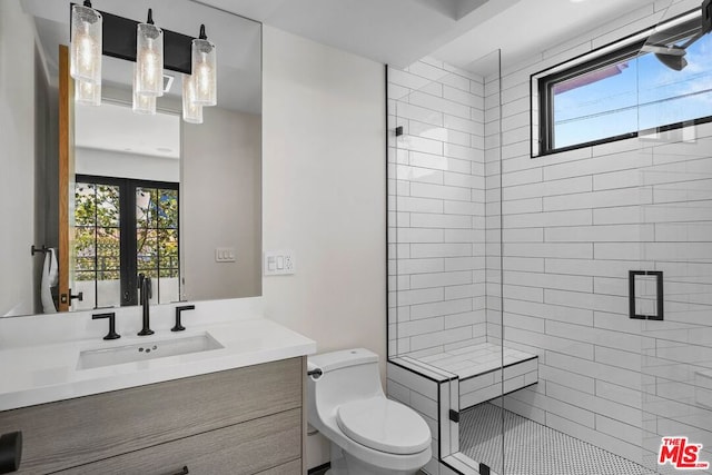 bathroom with toilet, a shower with door, and vanity