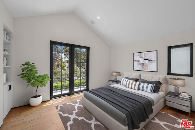 bedroom featuring access to outside, lofted ceiling, and light hardwood / wood-style flooring