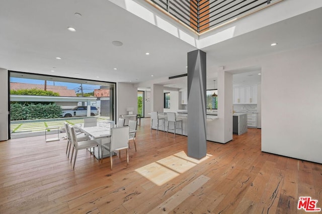 unfurnished dining area featuring light wood-type flooring