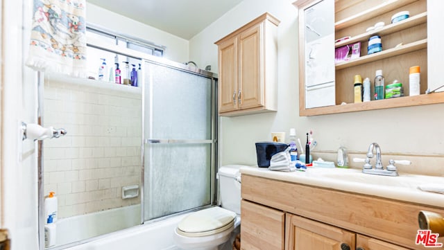 full bathroom with toilet, enclosed tub / shower combo, and vanity