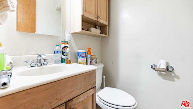 bathroom with toilet and vanity