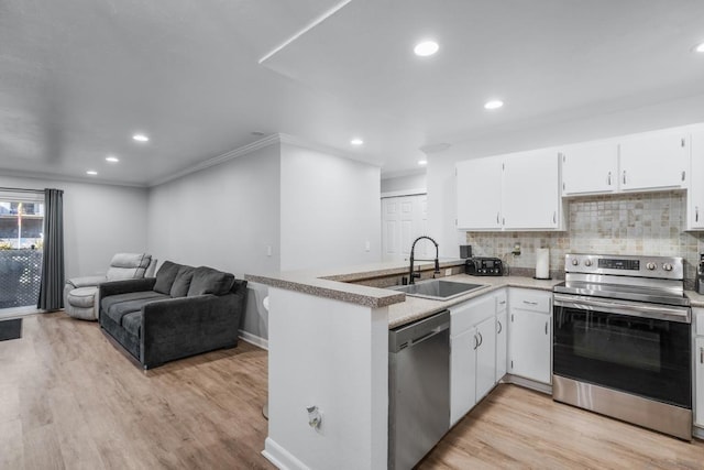 kitchen with white cabinetry, sink, stainless steel appliances, and light wood-type flooring