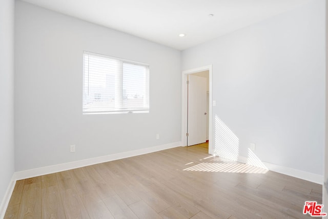 spare room featuring light hardwood / wood-style floors