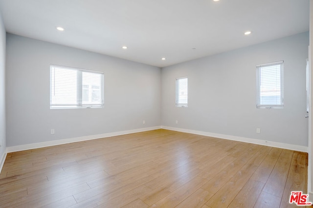 empty room with light hardwood / wood-style floors