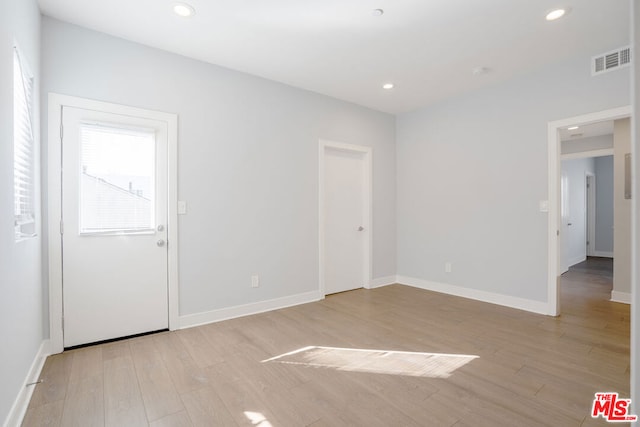 unfurnished room featuring light wood-type flooring