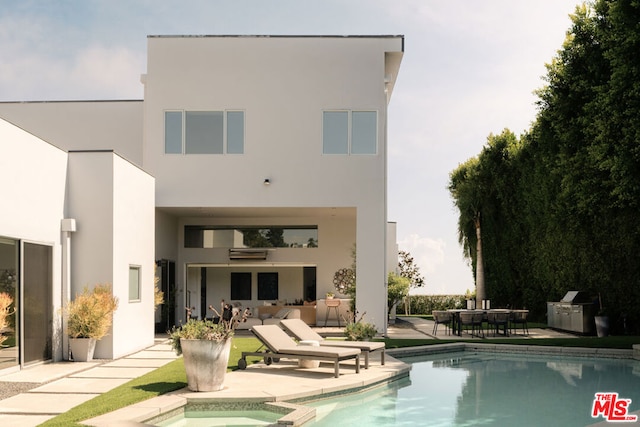 rear view of property featuring a patio area