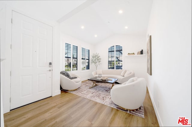 living room with vaulted ceiling and light hardwood / wood-style floors