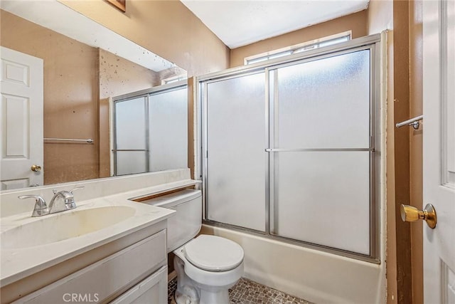 full bathroom featuring toilet, enclosed tub / shower combo, and vanity