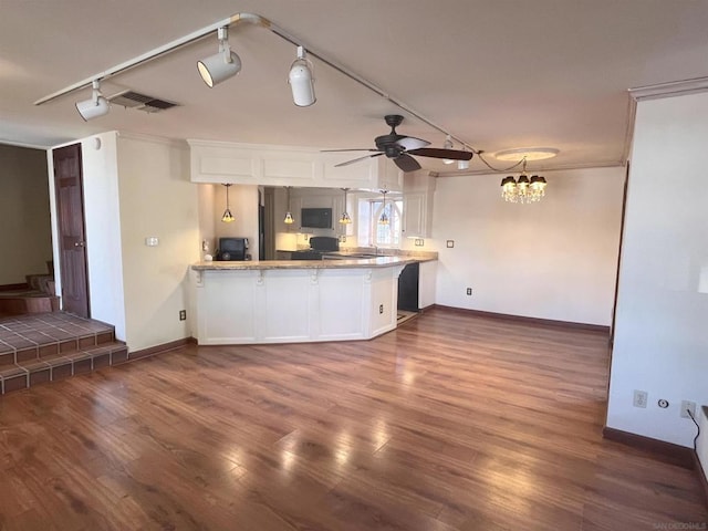 kitchen featuring kitchen peninsula, ceiling fan with notable chandelier, white cabinetry, and ornamental molding