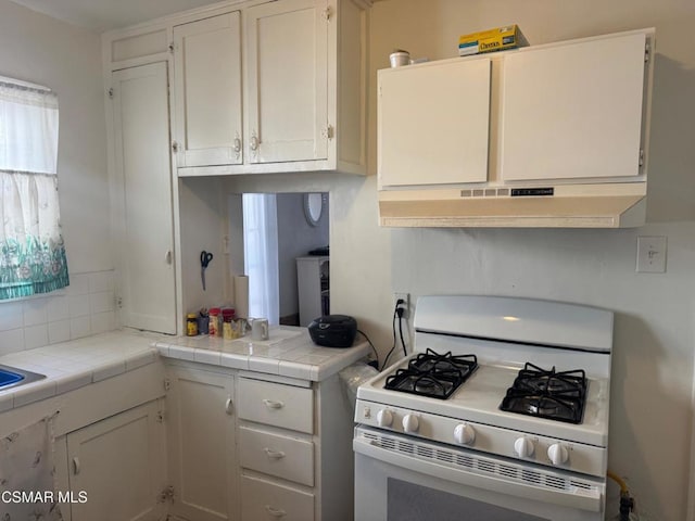 kitchen with white cabinetry, white range with gas cooktop, and tile counters