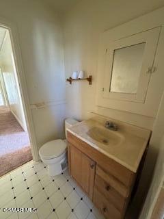 bathroom featuring toilet and vanity