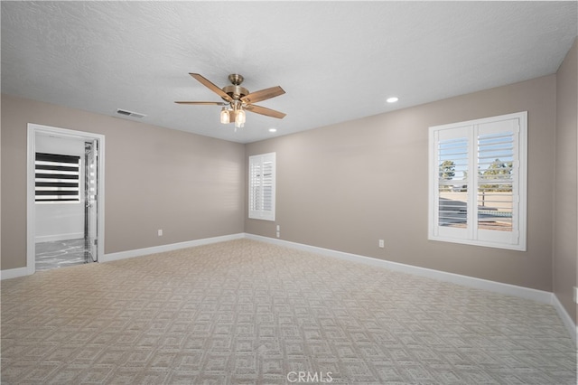 unfurnished room with a textured ceiling and ceiling fan