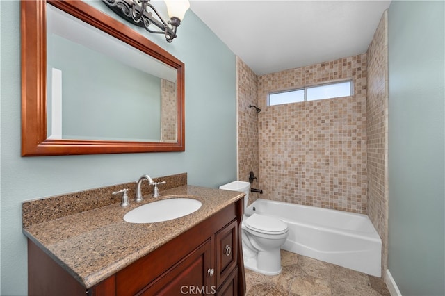 full bathroom with toilet, vanity, and tiled shower / bath