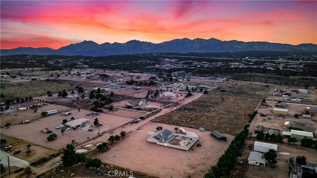 aerial view at dusk featuring a mountain view