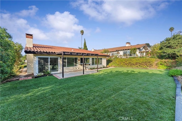 rear view of property with a patio and a yard