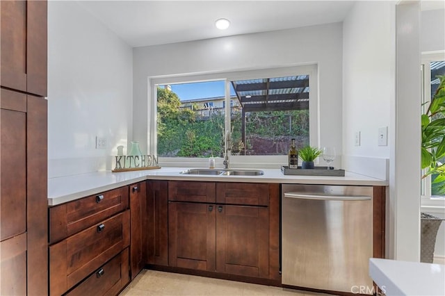 kitchen with dishwasher, dark brown cabinets, and sink