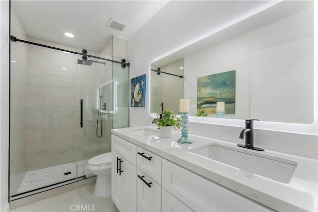 bathroom featuring toilet, tile patterned floors, walk in shower, and vanity