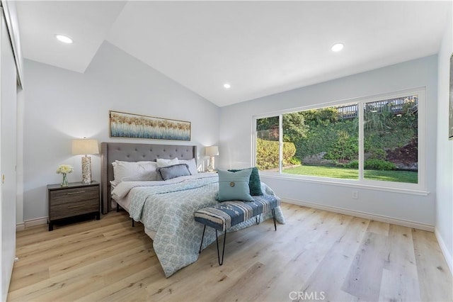 bedroom with light hardwood / wood-style flooring and vaulted ceiling