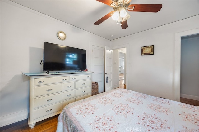 bedroom with ceiling fan and dark hardwood / wood-style floors