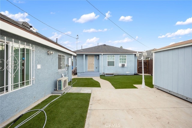 rear view of house with ac unit, a patio area, and a yard